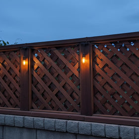 Frienda outdoor decor lit by string lights creating cozy backyard ambiance