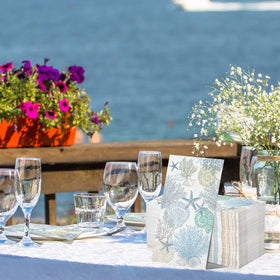 Funrous shell and coral napkins bring seaside charm to any table.
