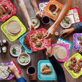 Gatherfun Fiesta Kit papel picado dinner plates bring festive flair to the table.