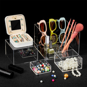 Geelin 6-pack acrylic risers stacked on a shelf for organized display.