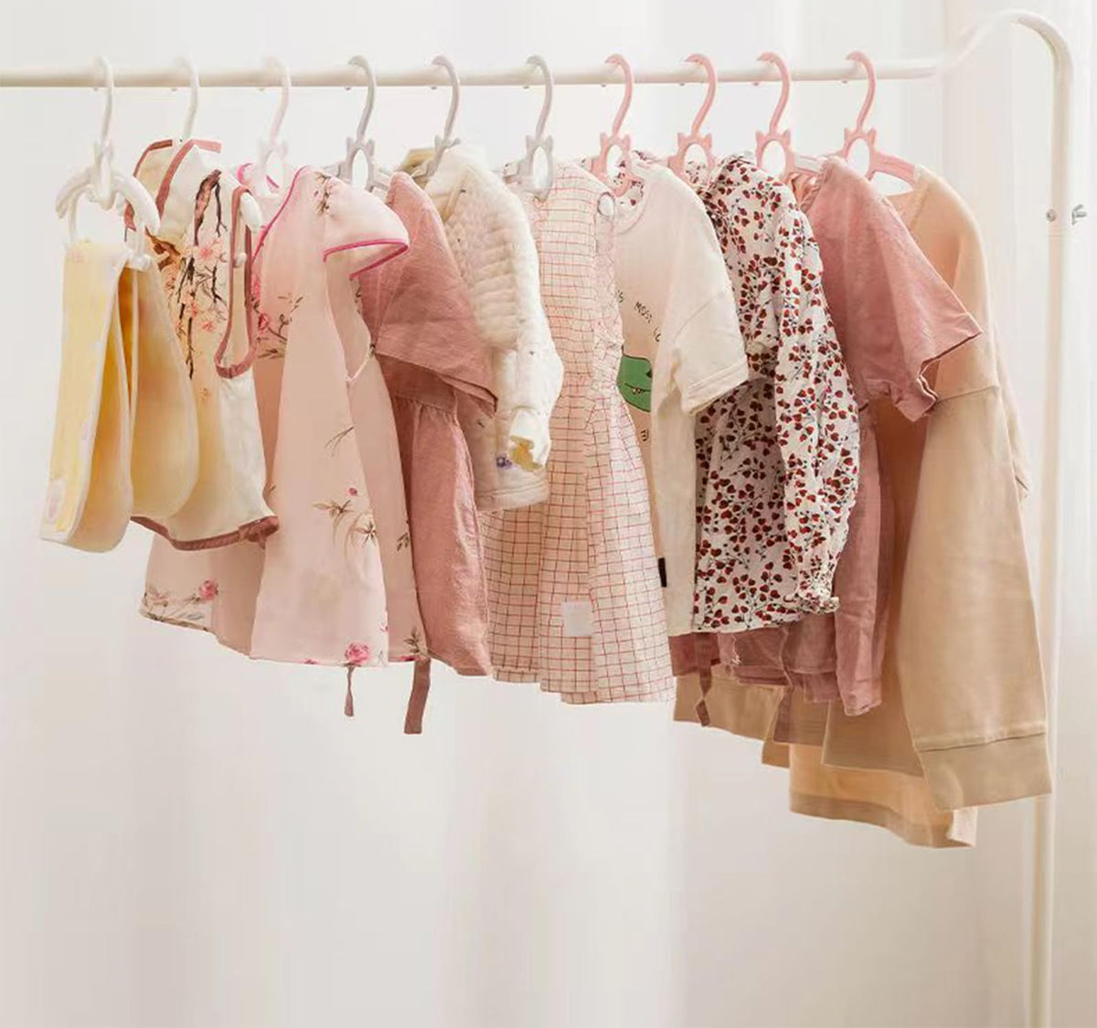 Gencuoir nursery hangers with side clips secure tiny garments.