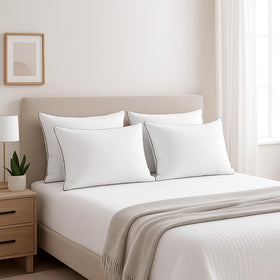 Generic machine-washable queen pillows for easy cleaning and loft retention.