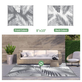 GENIMO outdoor rug reversible palm pattern on grey and white.