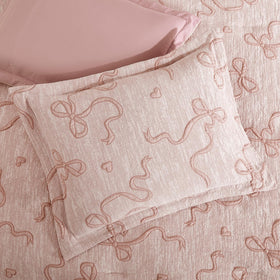 Geniospin bow-knot detail accents decorative charm on bedding