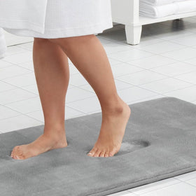 Genteele memory foam bath mat with non-slip backing for safe footing on slick floors.