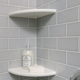 Geoona white marble corner shelf installed in a bathroom corner for towels