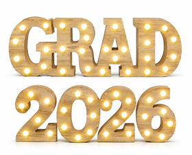 Gift Boutique Grad 2026 sign on a desk with warm LED glow for celebrations