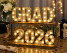 Gift Boutique Grad 2026 sign illuminated for photo backdrop and party ambiance