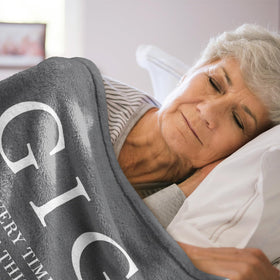 GiltGlimmer Gigi blanket on sofa adds cozy decor and warmth.