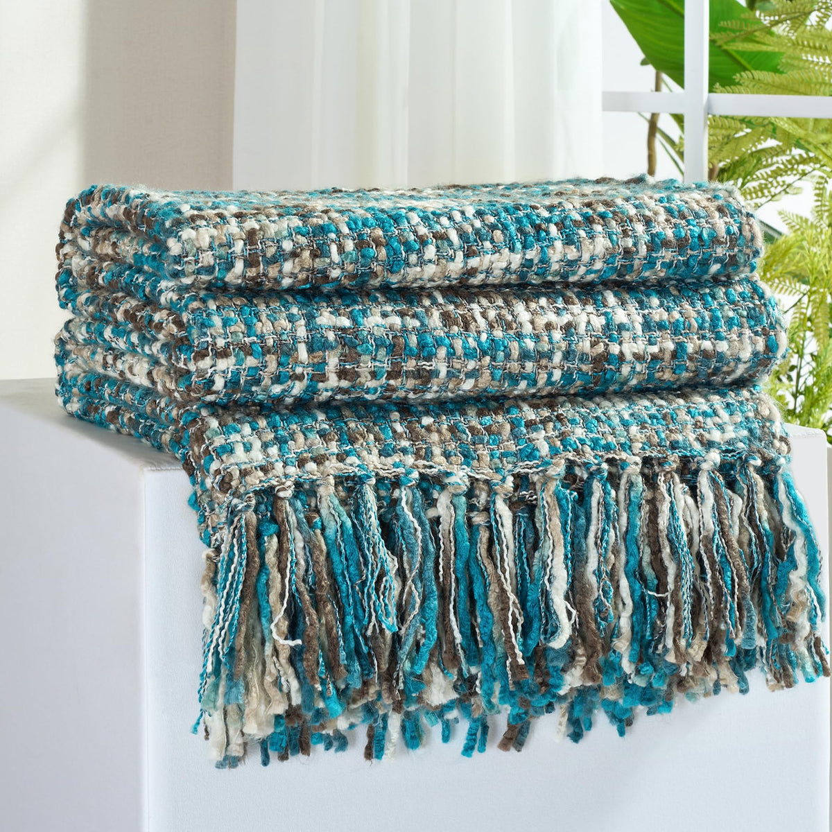 GINAMUSE multi-color teal throw on sofa showing cozy texture and warmth