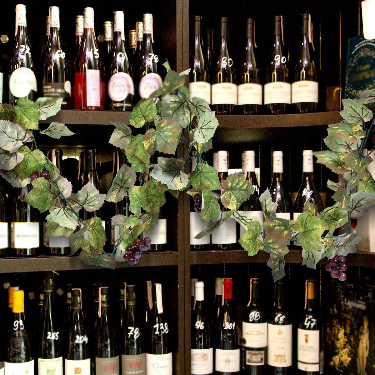 Glitinsel grape leaf garland showcases deep purple grape clusters for authentic detail.