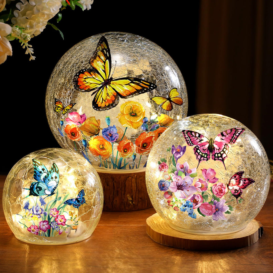 Glooglitter butterfly crackle glass ball lamp 10cm emits a soft ambient glow.
