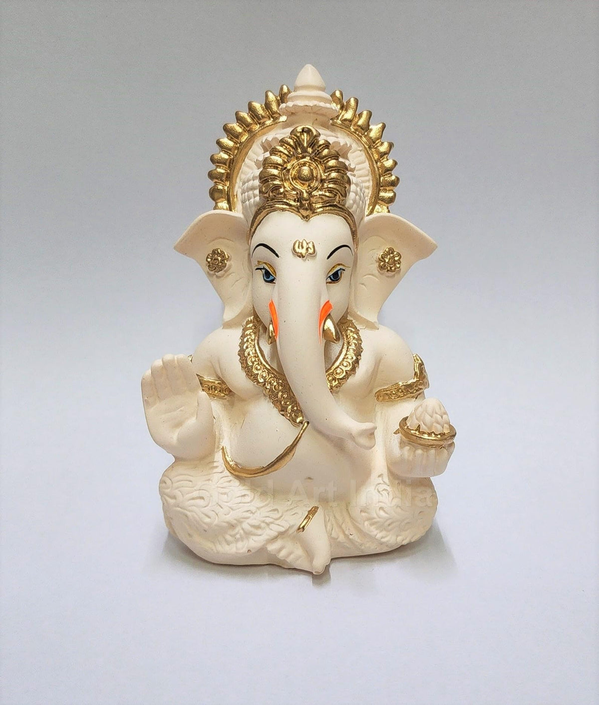 Gold Art India Ganesha idol on car dashboard with peach ivory finish.
