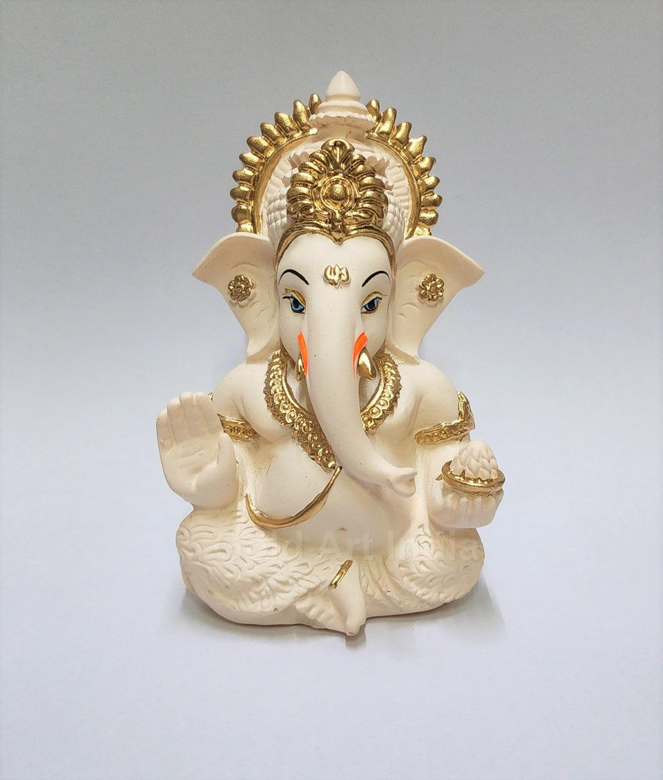 Gold Art India Ganesha idol on car dashboard with peach ivory finish.