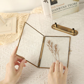 Goutangen frame on table with pressed flowers inside for décor.
