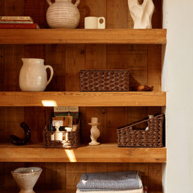 GRANNY SAYS bedside setup with wicker storage baskets in bedroom
