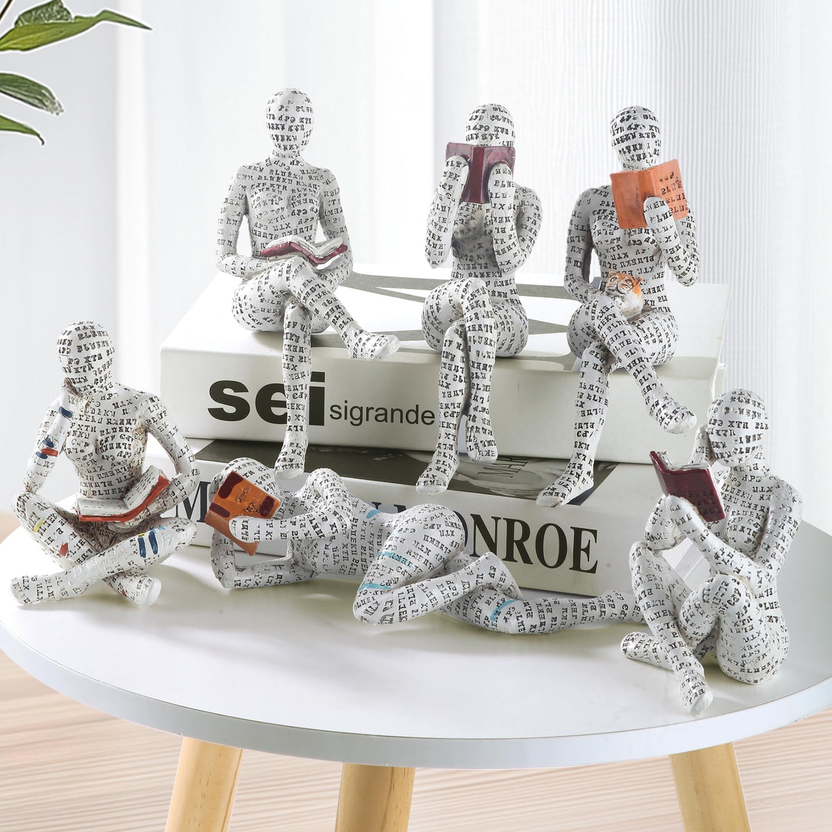 GRAPMKTG reading-woman-statue on a desk creates a scholarly workspace vibe