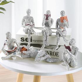 GRAPMKTG reading-woman-statue on a desk creates a scholarly workspace vibe