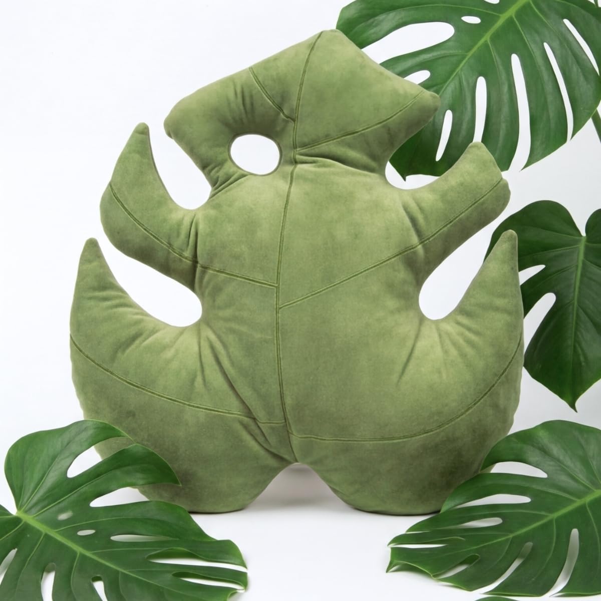 Green Philosophy Co. Monstera Leaf Pillow stack shows versatile styling options.