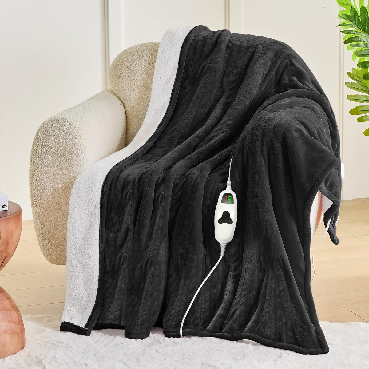 Greenoak heated blanket spread on sofa shows soft fleece for comfortable lounging.