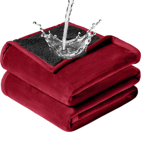 GROOSE waterproof blanket on a bed in wine red offering spill protection.
