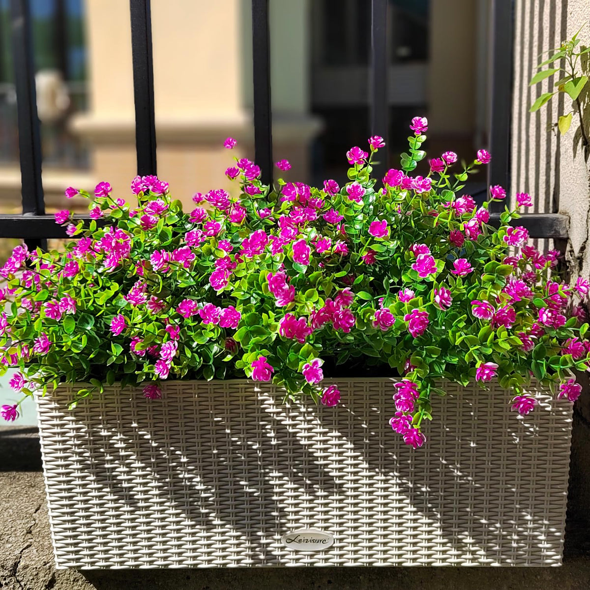 Grunyia magenta artificial flowers enhancing curb appeal and entryways.