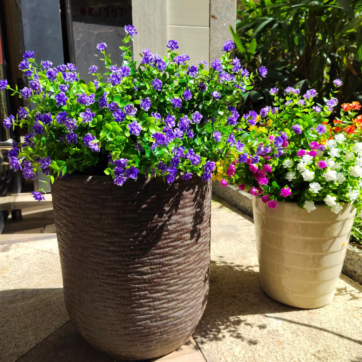 Grunyia purple outdoor artificial flowers arranged in a hanging planter.