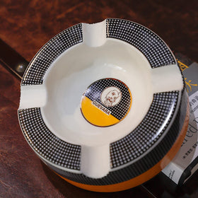 GUEVARA outdoor and indoor compatible ashtray with durable finish.