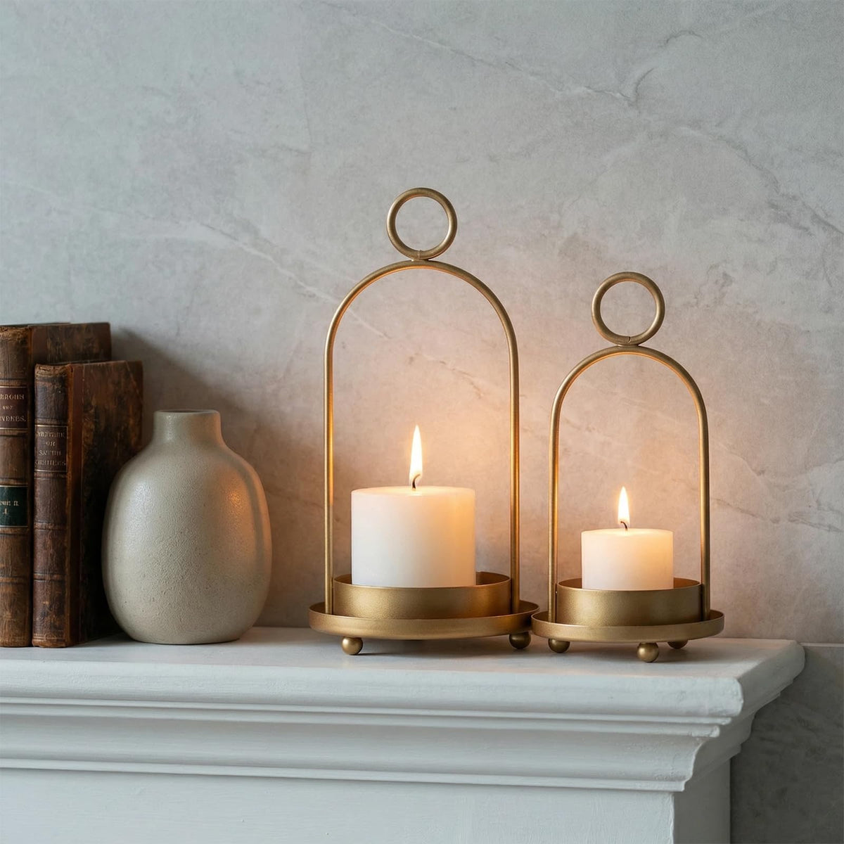 Two sizes of GYKLE lanterns displayed side by side on a mantel.