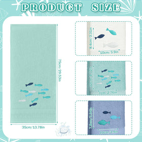 Hahafelt embroidered fish design towels in white, green, blue add coastal charm
