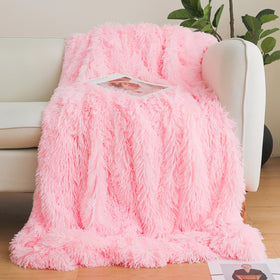 HAIHUA pink faux fur throw blanket on a sofa adds warm, stylish lounge decor.