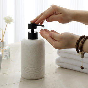 Haocoott lotion dispenser in beige resin close-up showing durable no-leak pump.