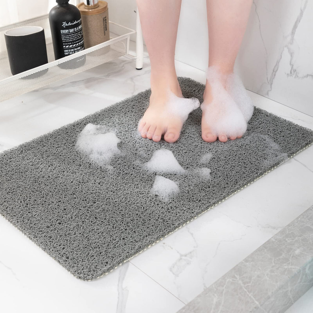 Hargiis non-slip shower mat in gray laid flat for bathroom safety.