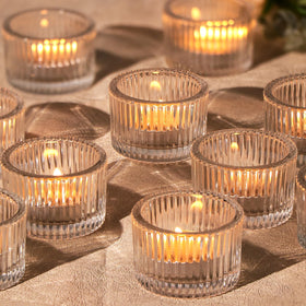 HAVITI clear tealight holders provide a versatile 24-pack for centerpieces.