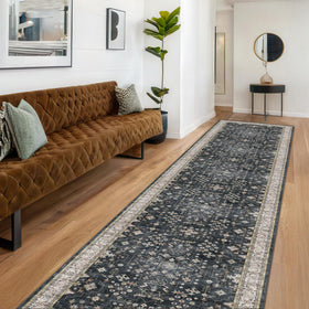 Hazo Haus Black Boho runner rug laid in a hallway with non-slip backing.