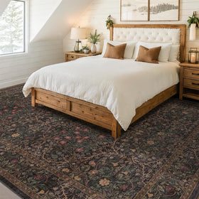 Hazo Haus dark brown backdrop rug with green vines and red berries enhances decor.