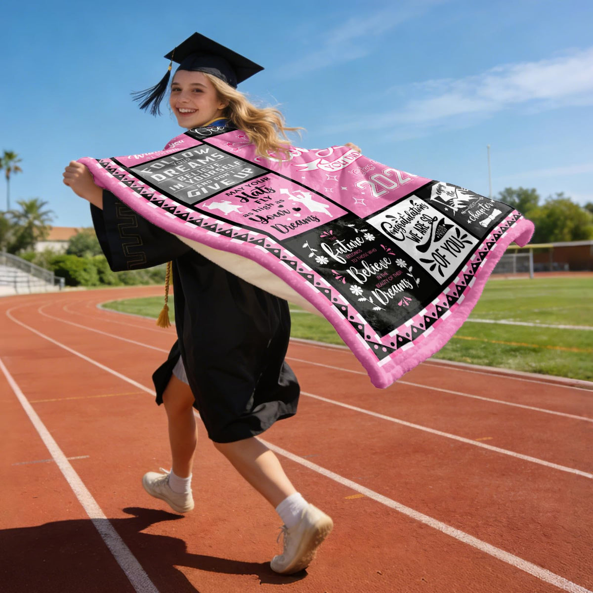 HCDER Class of 2026 gift blanket beside diploma prop.