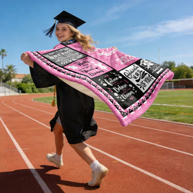 HCDER Class of 2026 gift blanket beside diploma prop.