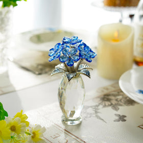 Blue glass flower ornament brightens tabletops and display cabinets