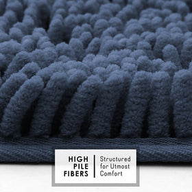 Hearth and Harbor bath rug with non-slip backing on smooth surface.