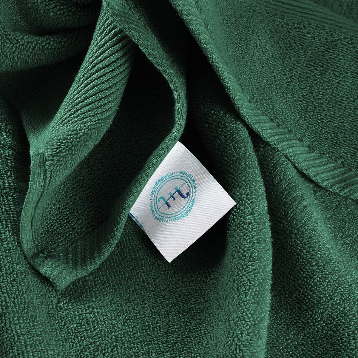 Hearth & Harbor hunter green towel display, elegant bathroom accent.
