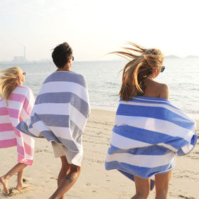 HENBAY towel spread on sand, ideal for a relaxed beach moment.