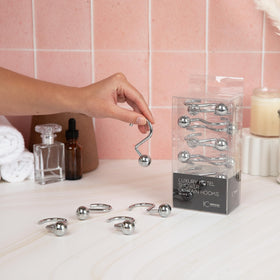 Hermosa Collection chrome finish hooks on a rod with a neat curtain