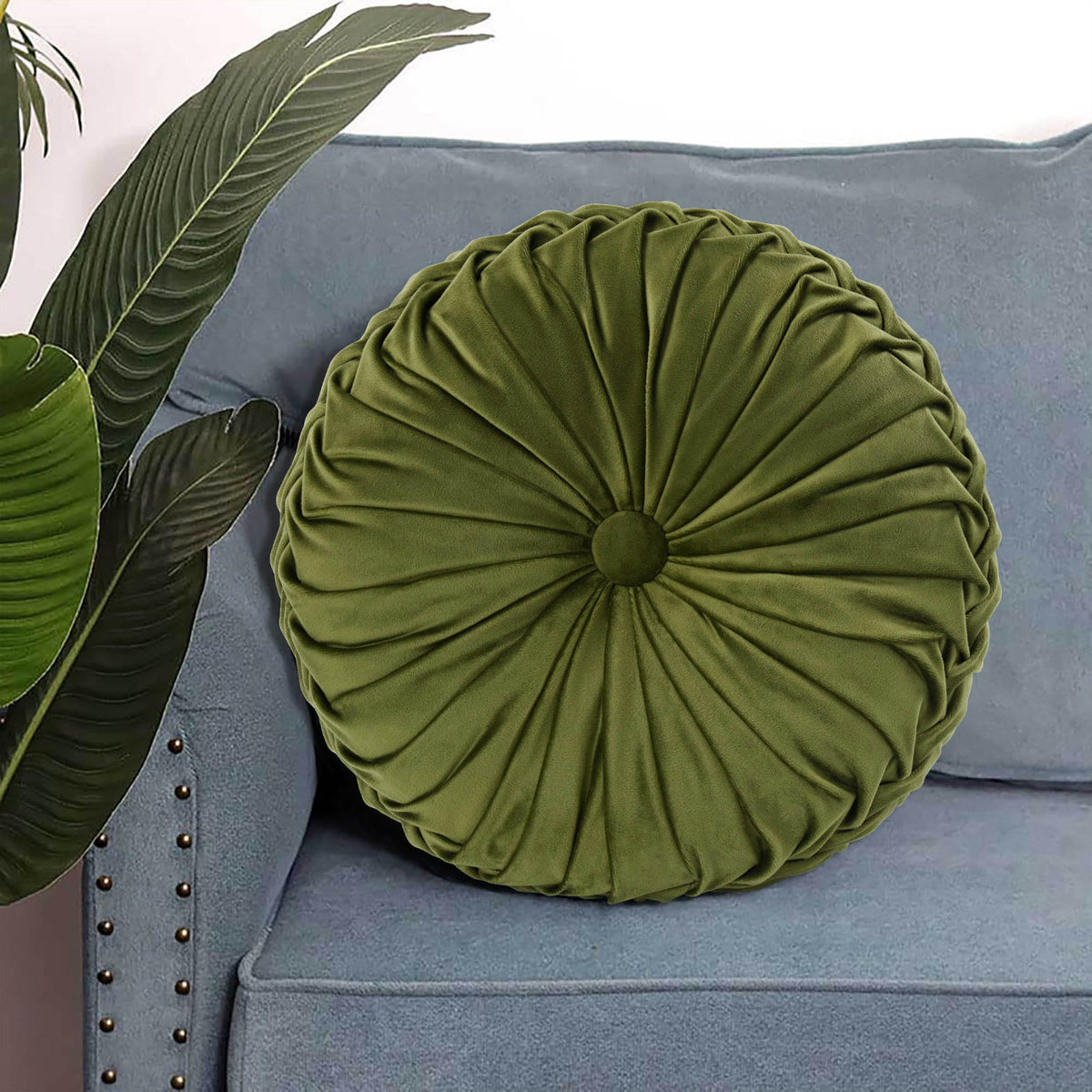 HIG Ripple olive round pillow layered with other cushions for depth