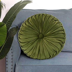 HIG Ripple olive round pillow layered with other cushions for depth