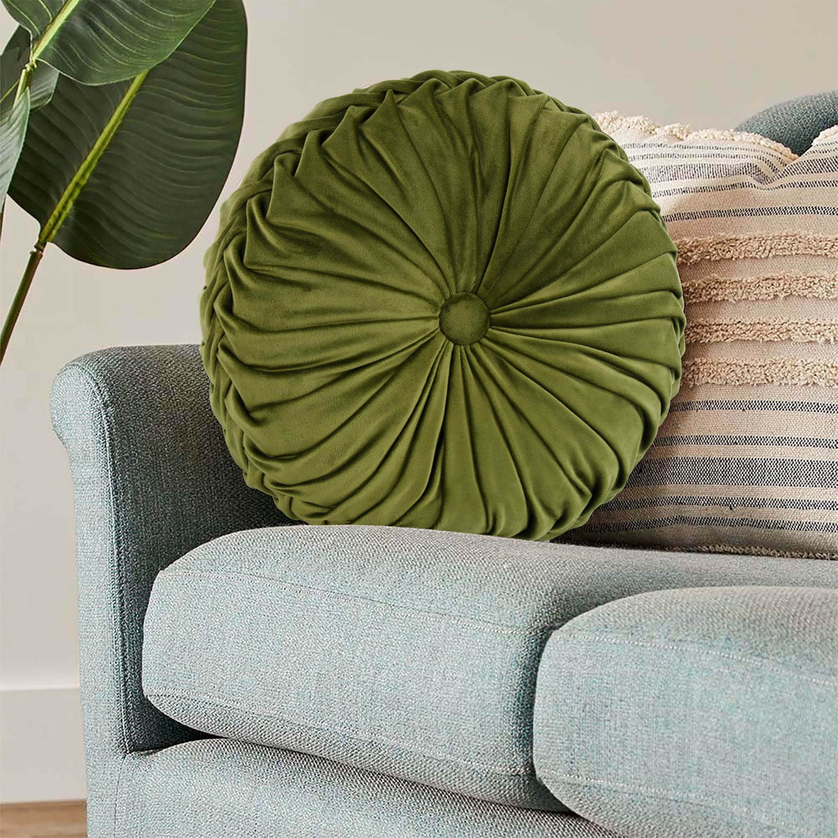 HIG Ripple olive round pillow outdoors in a covered space