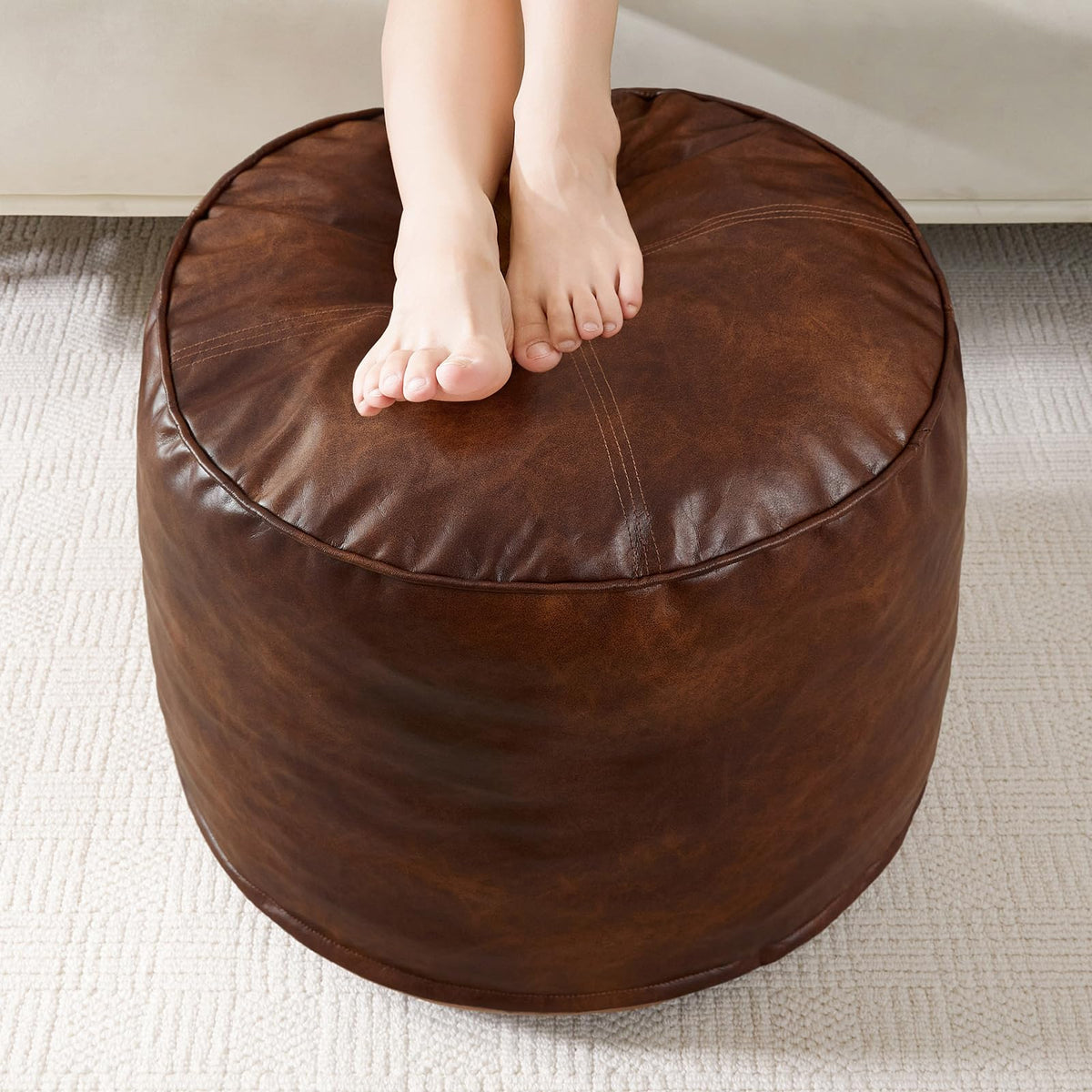 HIGOGOGO round stuffed pouf ottoman with plush outer layer for extra seating.