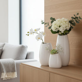 hjn white vases on mantel with greens and blooms