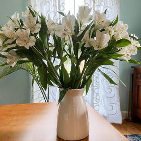 hjn white vase placed on mantel decorates the living space.