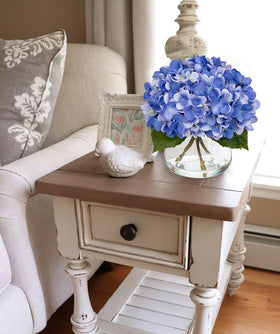 Hollyone green stems and leaves accent the lifelike arrangement